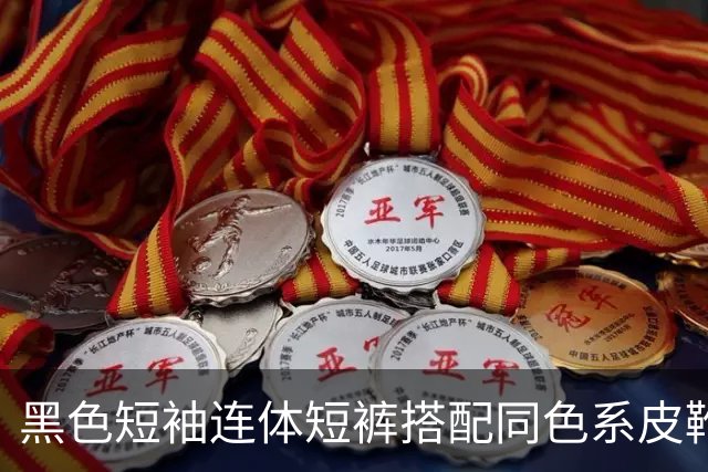 黑色短袖连体短裤搭配同色系皮靴，挺括面料利落勾勒流畅身形线条
